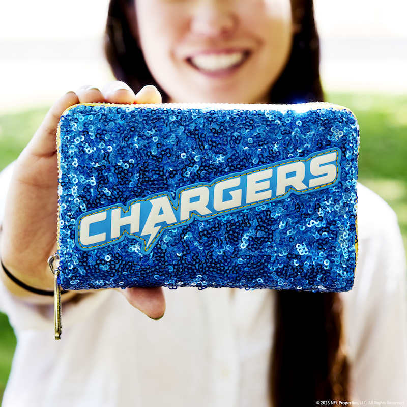 Woman holding the NFL Los Angeles Chargers Sequin Wallet out to camera 